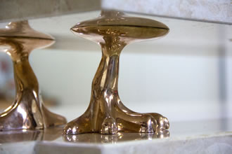 Pormenor garra em bronze fundido sustenta pedra lioz